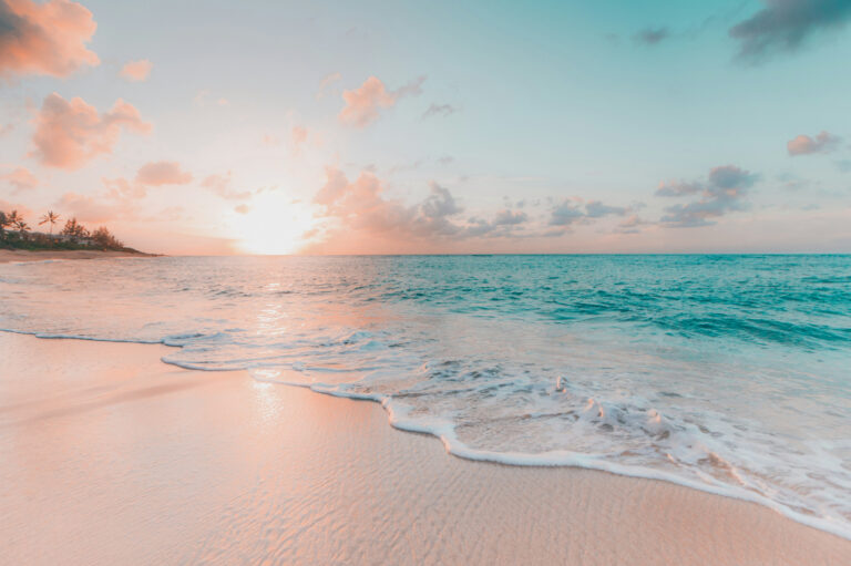 Pink sands and aqua ocean at sunset