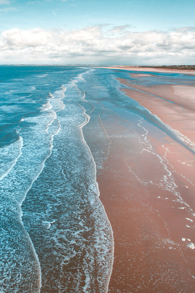 Wide angle image of ocean against a beach