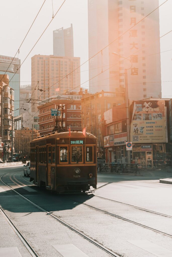 Asian trolley driving down a city street